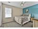 Bright bedroom with a pop of color features a double bed, ceiling fan, and side table at 150 Whitney Way, Fayetteville, GA 30214