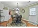 Inviting dining room features a round table, chandelier, and view into the kitchen, and door to the outside at 150 Whitney Way, Fayetteville, GA 30214