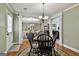 Inviting dining area with a round table, a chandelier, and a view into the living room and another dining area at 150 Whitney Way, Fayetteville, GA 30214