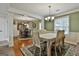 Elegant dining room with hardwood floors, chandelier lighting, and open view to the kitchen at 150 Whitney Way, Fayetteville, GA 30214