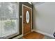 Inviting entryway with decorative glass door, hardwood floors, and natural light from the window at 150 Whitney Way, Fayetteville, GA 30214