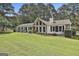 Charming ranch home features a spacious front yard, stone accents, and manicured landscaping at 150 Whitney Way, Fayetteville, GA 30214