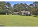 Charming ranch home features a spacious front yard, stone accents, and manicured landscaping at 150 Whitney Way, Fayetteville, GA 30214