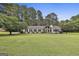 Charming ranch home features a spacious front yard, stone accents, and manicured landscaping at 150 Whitney Way, Fayetteville, GA 30214