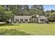 Charming ranch home features a spacious front yard, stone accents, and manicured landscaping at 150 Whitney Way, Fayetteville, GA 30214