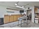 Functional garage with storage cabinets, a workspace with mounted TV, and visible office through open doorway at 150 Whitney Way, Fayetteville, GA 30214