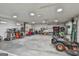 Spacious garage interior with concrete floor, ample lighting, and various tools and equipment at 150 Whitney Way, Fayetteville, GA 30214