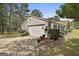 Home features a detached two-car garage with manicured landscaping and a charming birdhouse at 150 Whitney Way, Fayetteville, GA 30214