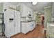 Well-equipped kitchen with white appliances, granite countertops, and ample cabinet space with a view into another living area at 150 Whitney Way, Fayetteville, GA 30214