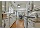 Bright kitchen with white cabinets, granite countertops, stainless steel appliances, and a view into the dining room at 150 Whitney Way, Fayetteville, GA 30214