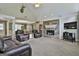 Large living room featuring stone fireplace, vaulted ceilings, and open layout to dining area at 150 Whitney Way, Fayetteville, GA 30214