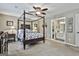Spacious bedroom features a four-poster bed, ceiling fan, and ensuite bathroom at 150 Whitney Way, Fayetteville, GA 30214