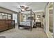 Spacious main bedroom features a four-poster bed, dresser, and neutral decor, creating a serene retreat at 150 Whitney Way, Fayetteville, GA 30214