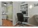 A functional office nook features built-in shelves, storage, and a compact desk setup for efficient work from home at 150 Whitney Way, Fayetteville, GA 30214