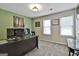 Home office with green accent wall featuring desk and two large windows at 150 Whitney Way, Fayetteville, GA 30214
