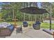 Back patio with wicker furniture, umbrella, and lush green lawn at 150 Whitney Way, Fayetteville, GA 30214