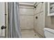 Close-up of the tiled walk-in shower with bronze fixtures and neutral tile at 150 Whitney Way, Fayetteville, GA 30214