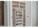 Walk-in closet features built-in shelving and storage for shoes and accessories at 150 Whitney Way, Fayetteville, GA 30214