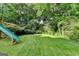 A spacious backyard with a lush green lawn and mature trees, offering plenty of room for outdoor activities at 1486 Maple Ridge Dr, Suwanee, GA 30024