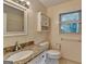 Clean bathroom features granite vanity, toilet, window with blinds, and large mirror at 1486 Maple Ridge Dr, Suwanee, GA 30024