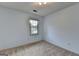 Simple bedroom with light blue walls, neutral carpet, and bright natural light from the window at 1486 Maple Ridge Dr, Suwanee, GA 30024