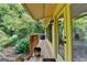 Covered deck with room to grill, potted plants, and stairs down to backyard at 1486 Maple Ridge Dr, Suwanee, GA 30024