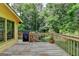 Wooden deck overlooks a sprawling backyard, mature trees and outdoor playset at 1486 Maple Ridge Dr, Suwanee, GA 30024