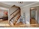 Inviting entryway with staircase, decorative sign, and hardwood flooring at 1486 Maple Ridge Dr, Suwanee, GA 30024