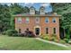 Charming two-story brick home featuring dormer windows and mature landscaping at 1486 Maple Ridge Dr, Suwanee, GA 30024