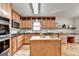 Well-equipped kitchen with an island, wood cabinetry, and recessed lighting at 1486 Maple Ridge Dr, Suwanee, GA 30024