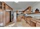 Large kitchen features light wood cabinets, stainless appliances, granite countertops, built in desk and center island at 1486 Maple Ridge Dr, Suwanee, GA 30024