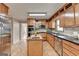Spacious kitchen features light wood cabinets, stainless appliances, granite countertops, and an island with sink at 1486 Maple Ridge Dr, Suwanee, GA 30024