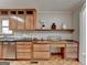 Bright kitchen features light wood cabinets, stainless dishwasher, granite countertops, and built in desk with shelving at 1486 Maple Ridge Dr, Suwanee, GA 30024