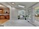 Bright sunroom with vaulted ceilings, skylights, large windows, and direct access to the kitchen and deck at 1486 Maple Ridge Dr, Suwanee, GA 30024