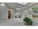 Spacious sunroom with vaulted ceilings, skylights, many windows, access to the deck, and neutral walls at 1486 Maple Ridge Dr, Suwanee, GA 30024