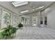 Open sunroom with skylights, large windows with wooded views, and neutral walls at 1486 Maple Ridge Dr, Suwanee, GA 30024
