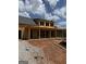 New construction showing long covered porch and garage, framed with wood and featuring a gray shingled roof on a sunny day at 51 Alatus Rd, Hogansville, GA 30230