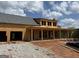 New construction showing covered porch and garage, framed with wood and featuring a gray shingled roof on a sunny day at 51 Alatus Rd, Hogansville, GA 30230