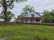 Charming farmhouse with a classic design and inviting front porch nestled in a serene country setting at 51 Alatus Rd, Hogansville, GA 30230