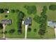 Aerial view of a residential home with lush landscaping and a long driveway at 105 Carols Ln, Locust Grove, GA 30248
