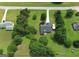 High-angle shot of a neighborhood home surrounded by large, verdant trees and lawns at 105 Carols Ln, Locust Grove, GA 30248