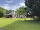 Spacious backyard with covered patio and well-maintained lawn at 105 Carols Ln, Locust Grove, GA 30248
