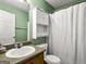 Well-lit bathroom with linoleum flooring, a commode and a shower at 105 Carols Ln, Locust Grove, GA 30248