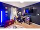 Bedroom with blue lighting featuring gaming console, chair, television, and desk at 105 Carols Ln, Locust Grove, GA 30248