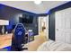 Modern bedroom featuring a gaming setup, dark walls, and blue LED lighting, perfect for entertainment at 105 Carols Ln, Locust Grove, GA 30248
