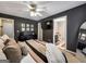 Comfortable bedroom showcases dark walls, neutral bedding, and an en-suite bathroom at 105 Carols Ln, Locust Grove, GA 30248