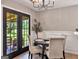 Cozy dining room features a modern light fixture and stylish seating for four, with outdoor views at 105 Carols Ln, Locust Grove, GA 30248