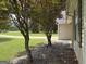 Landscaped side yard featuring ornamental trees and a stone groundcover at 105 Carols Ln, Locust Grove, GA 30248