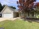 Charming single story home featuring an attached garage and a lovely red maple tree at 105 Carols Ln, Locust Grove, GA 30248