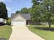 Inviting one-story home with attached garage, lush lawn, and RV parking at 105 Carols Ln, Locust Grove, GA 30248